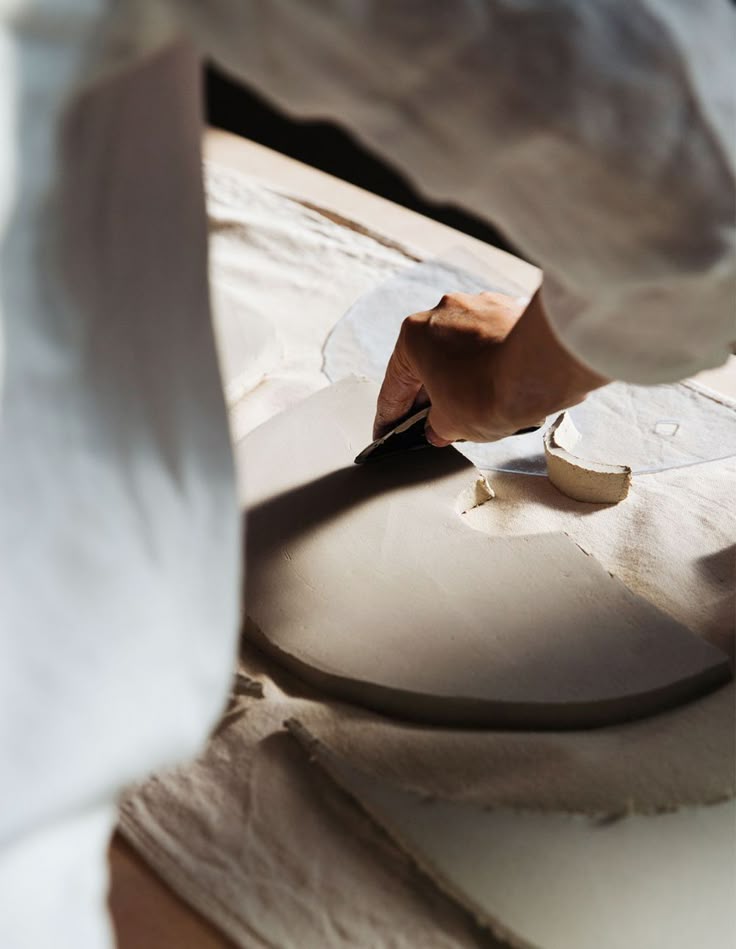 Hands shaping clay